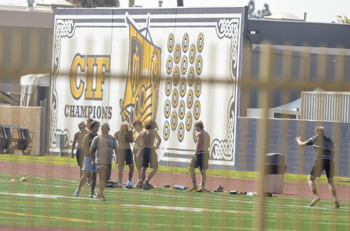 Marina High School football players work out on campus Tuesday in Huntington Beach.