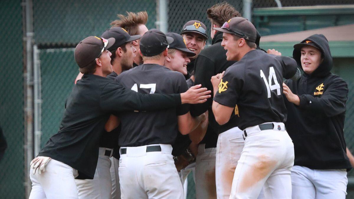 Capistrano Valley players celebrate their 4-2 win over Orange Lutheran in the Southern Section Division 1 semifinal baseball playoff game at Hart Park in Orange on Tuesday.