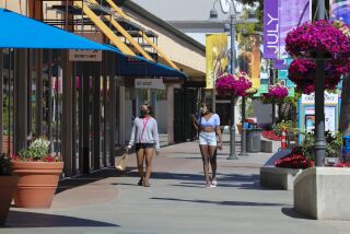 At The Grossmont Center outdoor shopping mall in La Mesa, shoppers walk down the center of the mall which has moved into Phase 2. Late Wednesday night the State of California approved San Diego County's plan for Phase 2 of the reopening plan.