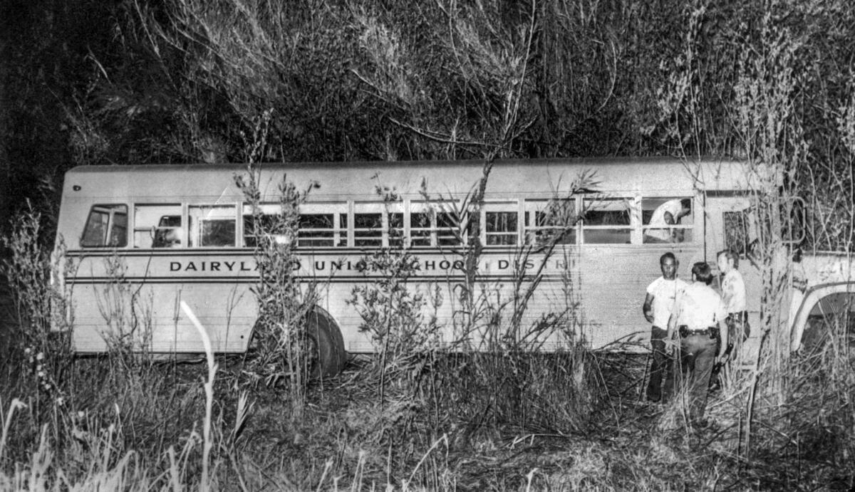 July 16, 1976: Police and parents inspect the Dairyland Union school bus after it was found near Chowchilla with all 26 students and driver missing. The man facing the camera is Denver Williams, whose daughter Lisa, 12, was among the missing.