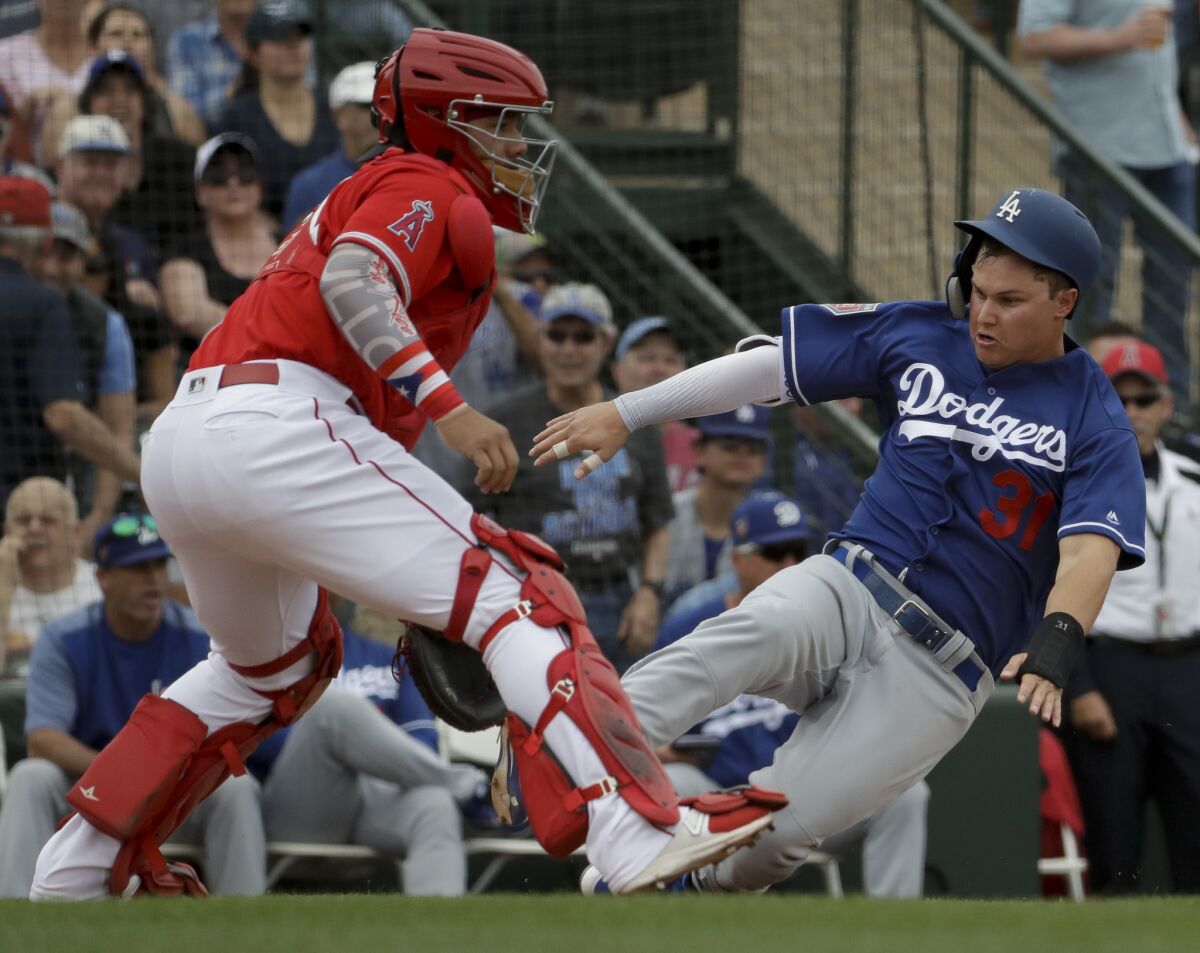 Los Angeles Dodgers' Joc Pederson scores past Los Angeles Angels catcher Rene Rivera on a double by Logan Forsythe during the second inning of a spring baseball game in Tempe, Ariz., Wednesday, March 7, 2018.