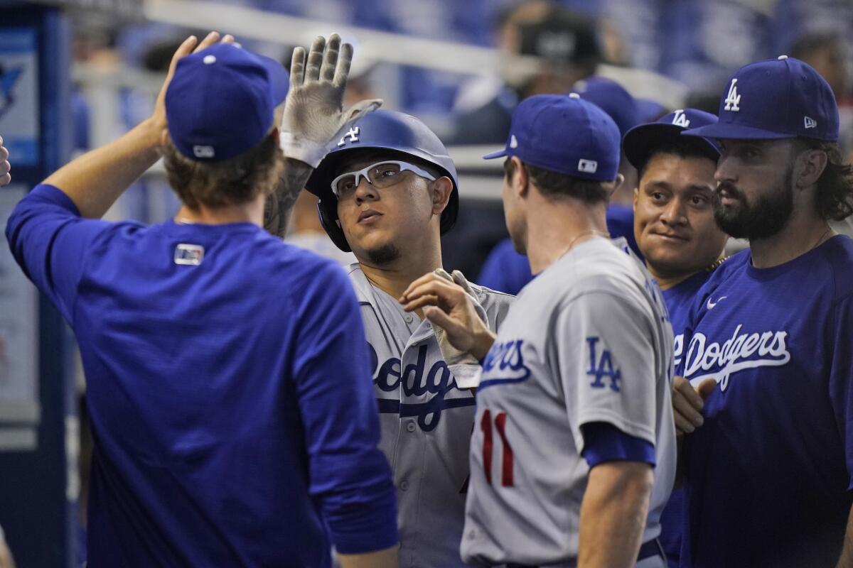  Julio Urias and a teammate high-five.