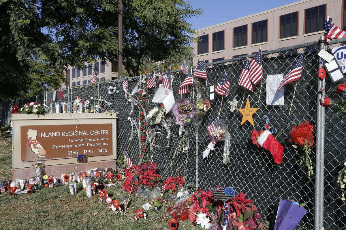 Flowers and American flags honoring the victims of the San Bernardino attack a few days after the assault are placed outside the Inland Regional Center where the fatal shooting took place.