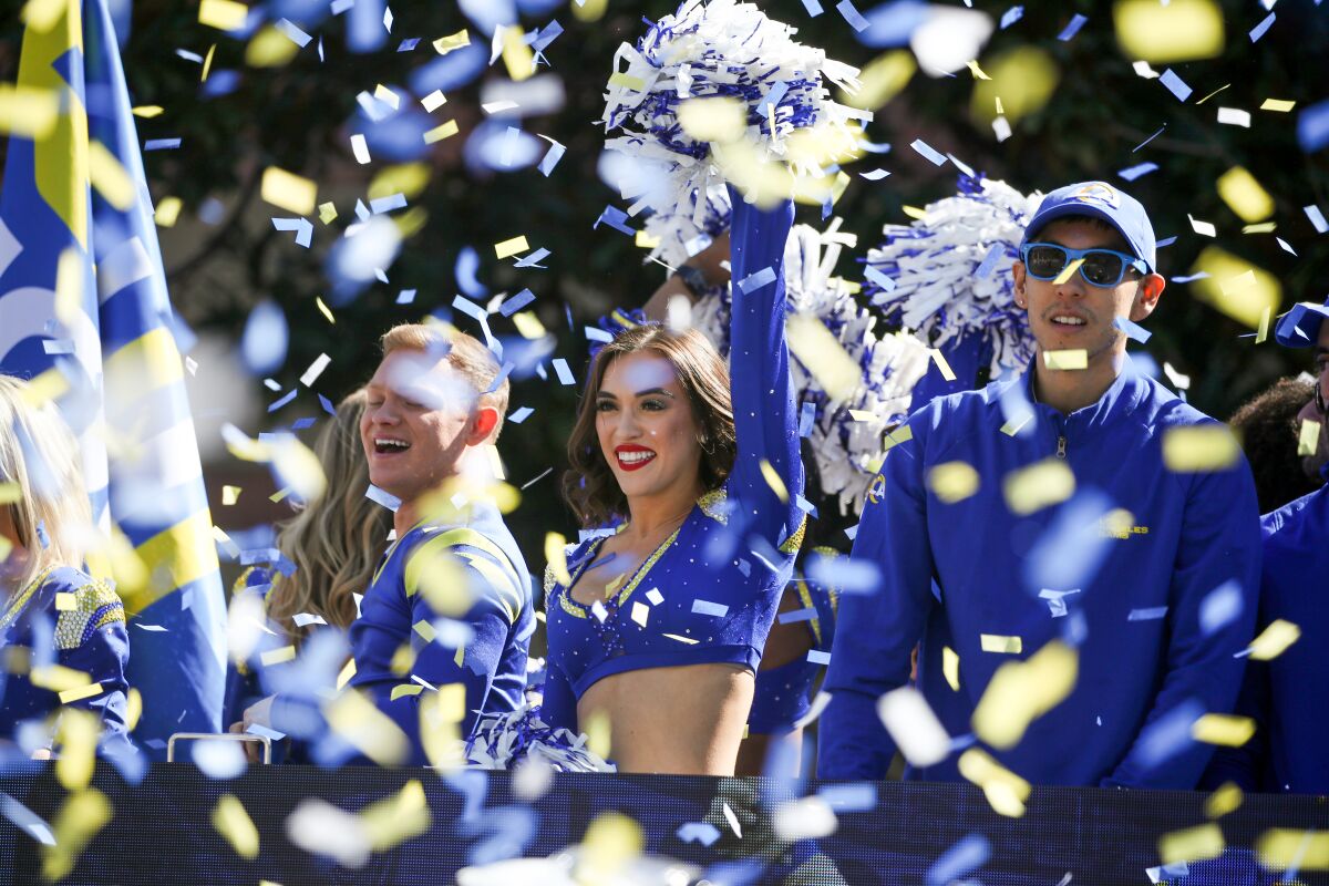 Confetti flies as a Rams cheerleaders cheer during the Rams victory parade to celebrate their Super Bowl win
