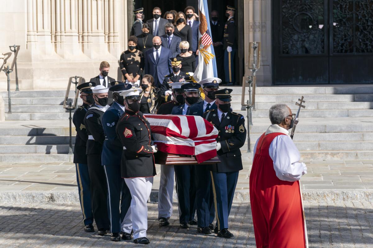 The flag-draped casket of former Secretary of State Colin Powell is carried from Washington National Cathedral