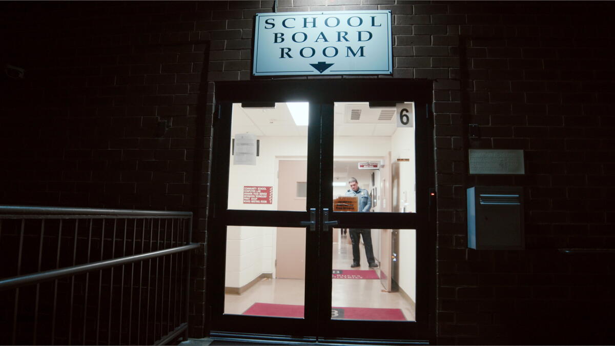 A doorway with a sign reading "school board room" above it.