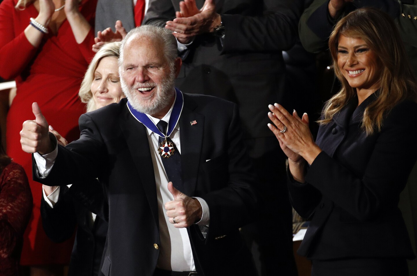 Rush Limbaugh reacts after first Lady Melania Trump presented him with the the Presidential Medal of Freedom as President Donald Trump delivers his State of the Union address to a joint session of Congress on Capitol Hill in Washington, Tuesday, Feb. 4, 2020. Second lady Karen Pence is at left and Kathryn Limbaugh is partially hidden. (AP Photo/Patrick Semansky)