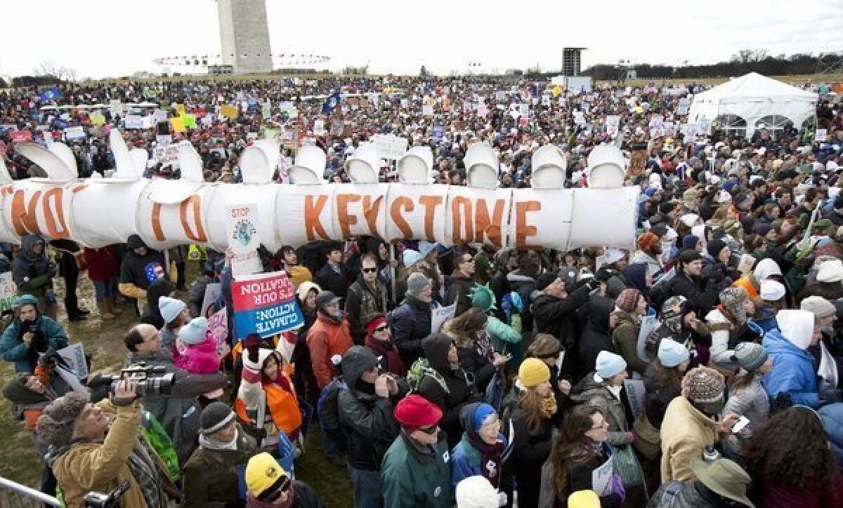Protesters gather at the National Mall in Washington last month to oppose the Keystone XL oil pipeline. A draft of a new State Department review says the project's effect on the environment would be minimal.