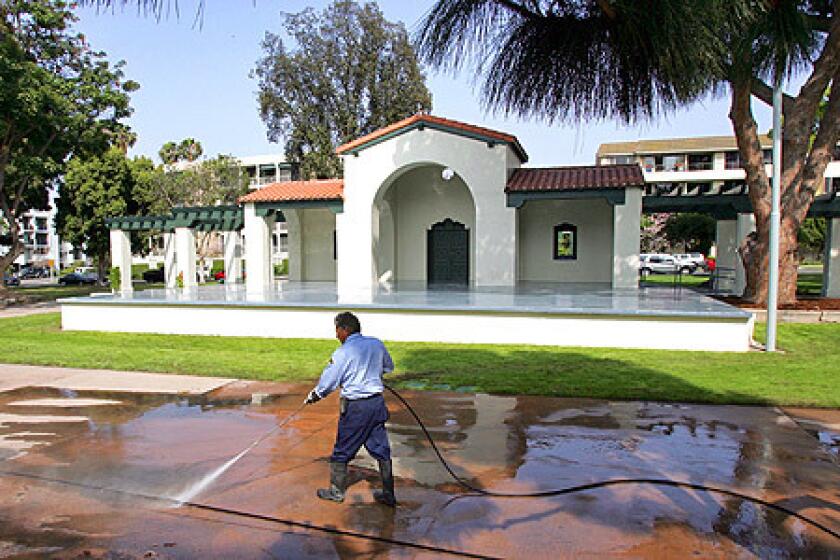 Long Beach city worker Luis Oviedo was washing down the pavement at Bixby Park in Long Beach on May 9, 2008. The Bixby Park band shell in Long Beach has been refurbished and re-opens today.