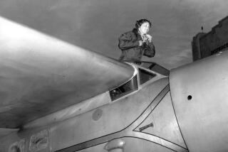 American aviatrix Amelia Earhart climbs from the cockpit of her plane at Los Angeles.