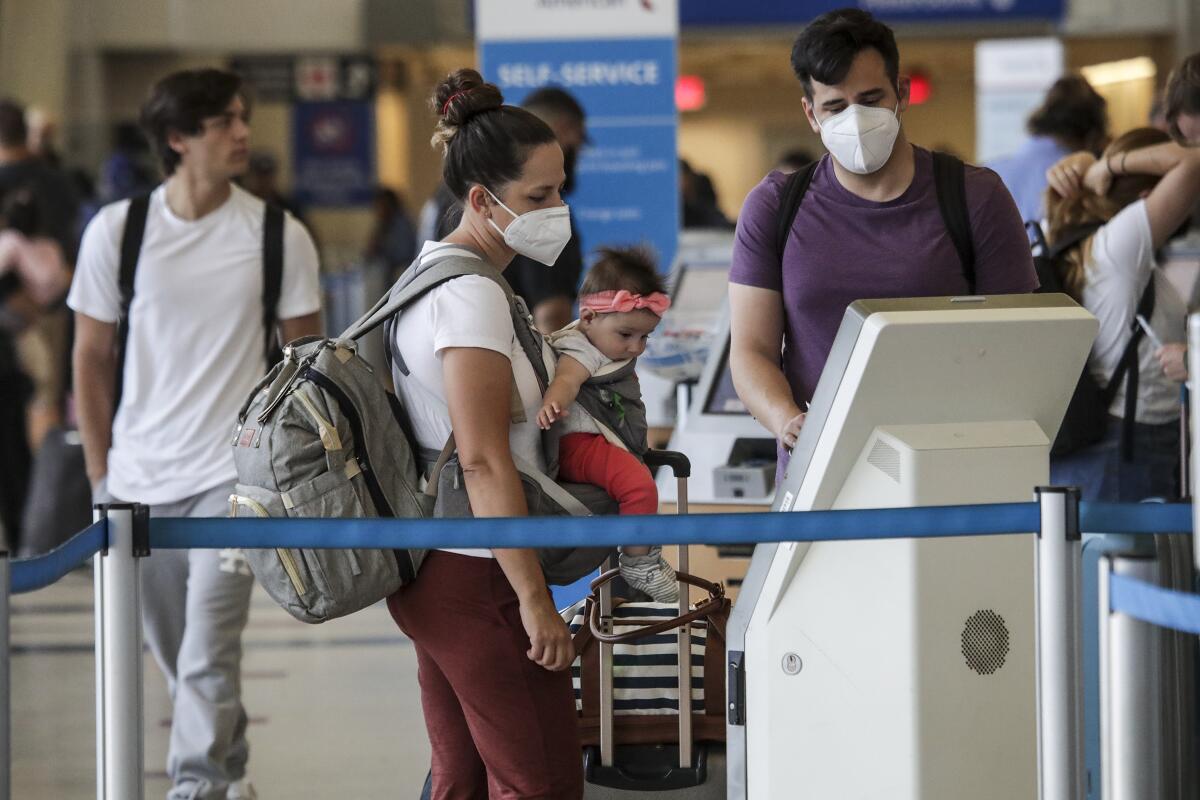 Passengers at L.A. airport wearing face masks 