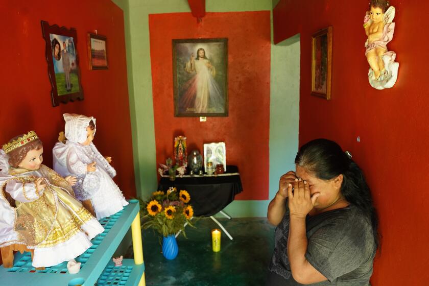 Isabel Baez Vaquero, 54, mourns the loss of her husband, Benito Medardo Tlatelpa Calixto, 58.at their home in the town oh Ahuehuetitla Mexico. He died April 13 in United States of Covid-19. His ashes were returned in July to Ahuehuetitla. The family set up an altar in their house with the urn containing his ashes.In recent months, Mexican authorities have been repatriating to Mexico the ashes of hundreds of Mexican citizens who died of Covid-19 in the United States. Health restrictions during the pandemic largely made it impossible to send back bodies to Mexico. Among the hardest-hit towns was Ahuehuetitla, in Puebla state, which has long sent migrants to the New York City area. In all, authorities say, 26 people from Ahuehuetitla died of Covid-19 in the United States.