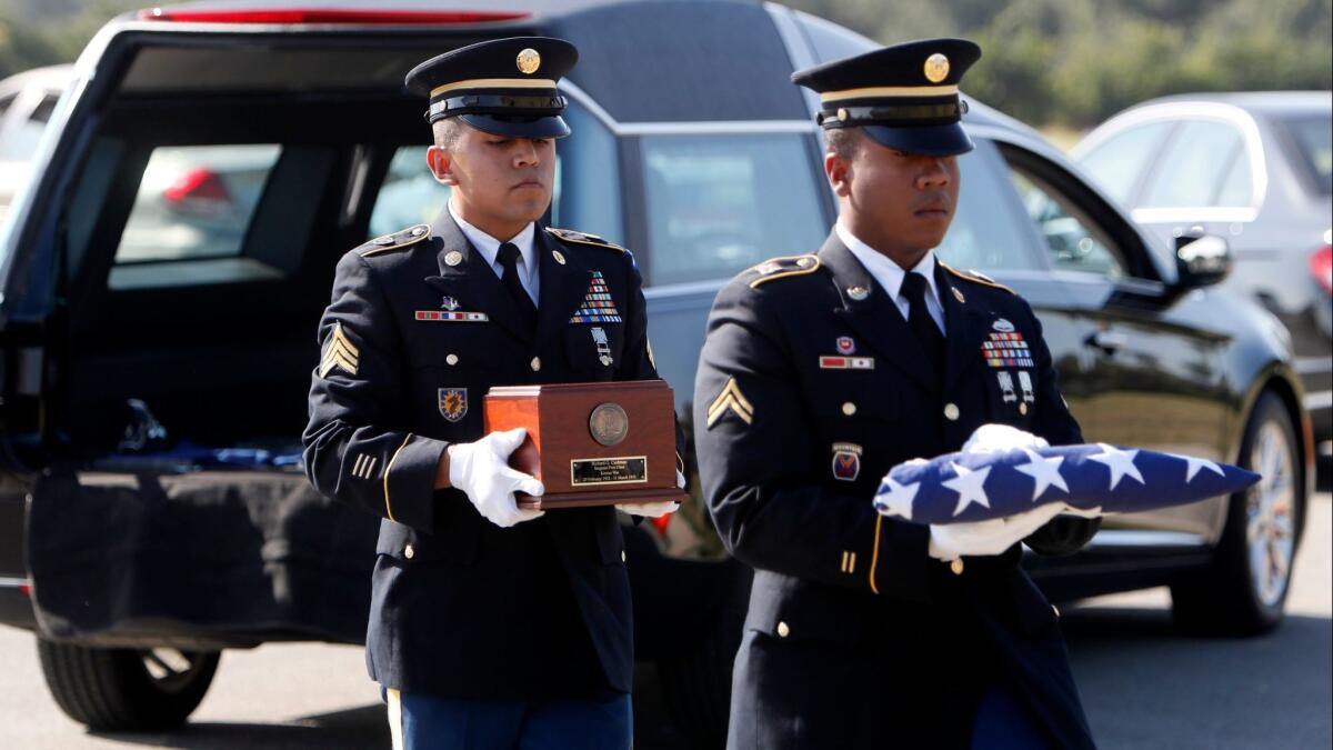 California National Guard Cpl. Serapio Alvarez, right, carries a U.S. flag and National Guard Sgt. Leonardo Becerra carries the remains of Army Sgt. 1st Class Richard G. Cushman at Cushman's funeral on Feb. 3 in Cypress.