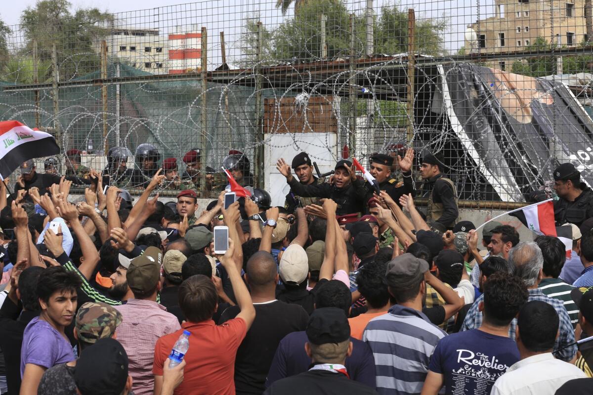 Security forces try to stop supporters of Shiite cleric Muqtada Sadr from storming parliament in Baghdad's Green Zone on April 30, 2016.