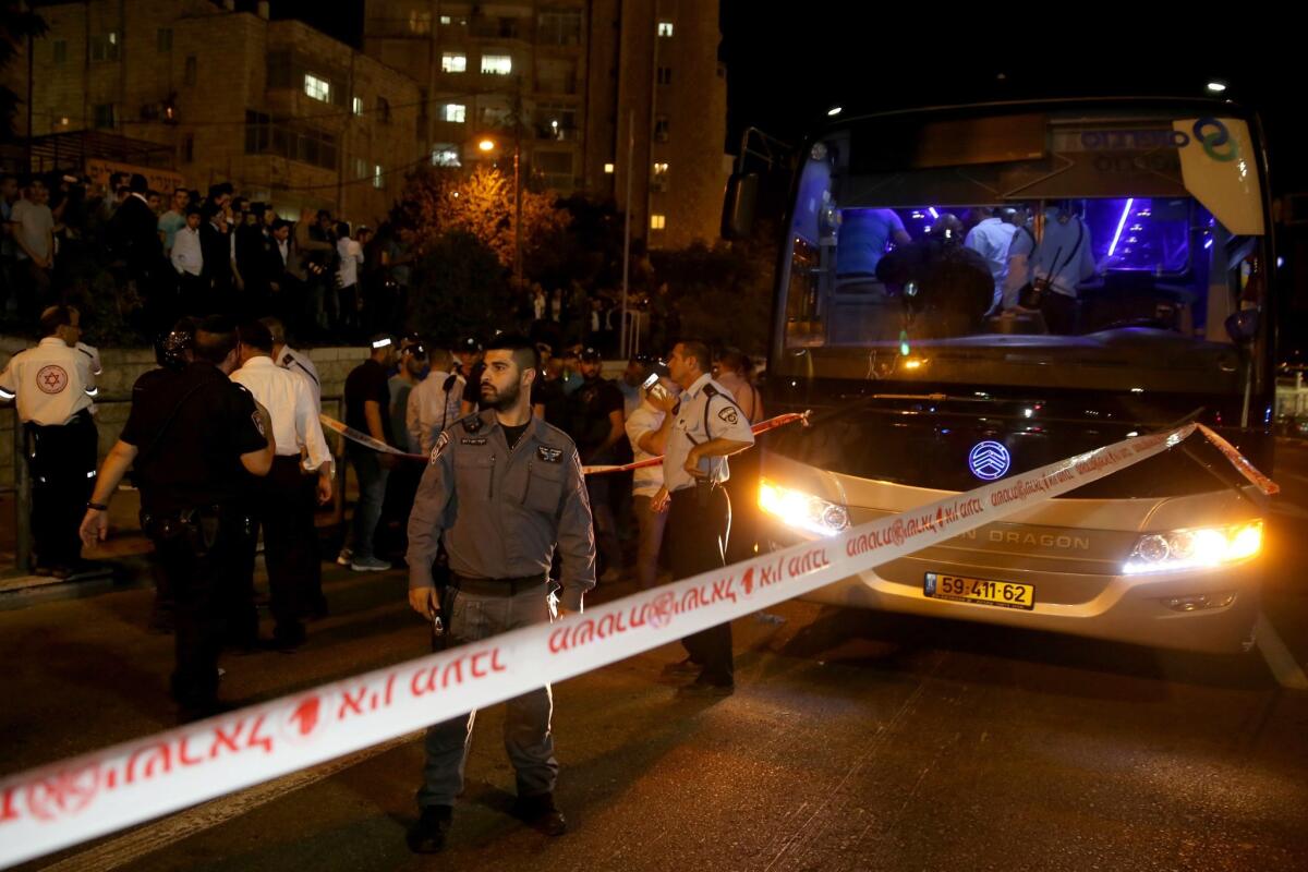 Israeli security forces and medics gather at the scene where an Arab man on a Jerusalem bus stabbed an off-duty Israeli soldier and tried to grab his weapon, lightly wounding him, before being shot dead by security forces on Oct. 12, 2015.