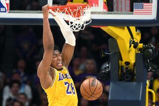 Lakers' Rui Hachimura dunks over Nuggets' Kentavious Caldwell-Pope during a basketball game.