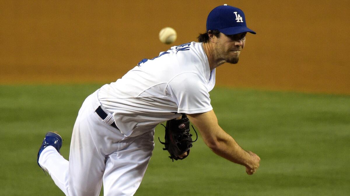 Dodgers starter Dan Haren delivers a pitch during the team's 6-5 win over the Miami Marlins on Monday.