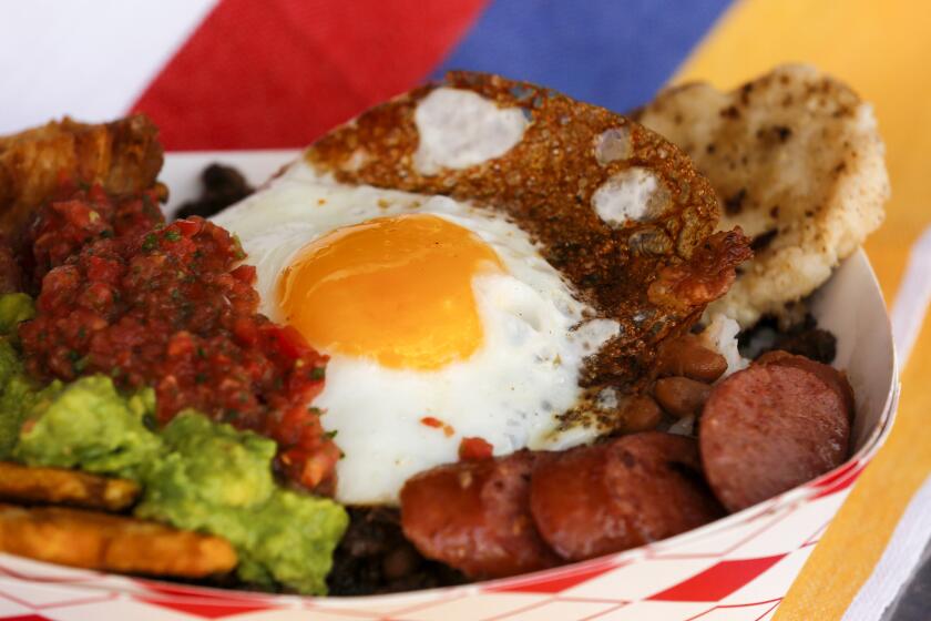 The Paisa Bowl is a protein-packed serving of pork belly, steak, sausage, beans, white rice, plantains, avocado and an arepa topped with a fried egg, from the Cali Fresh food truck.