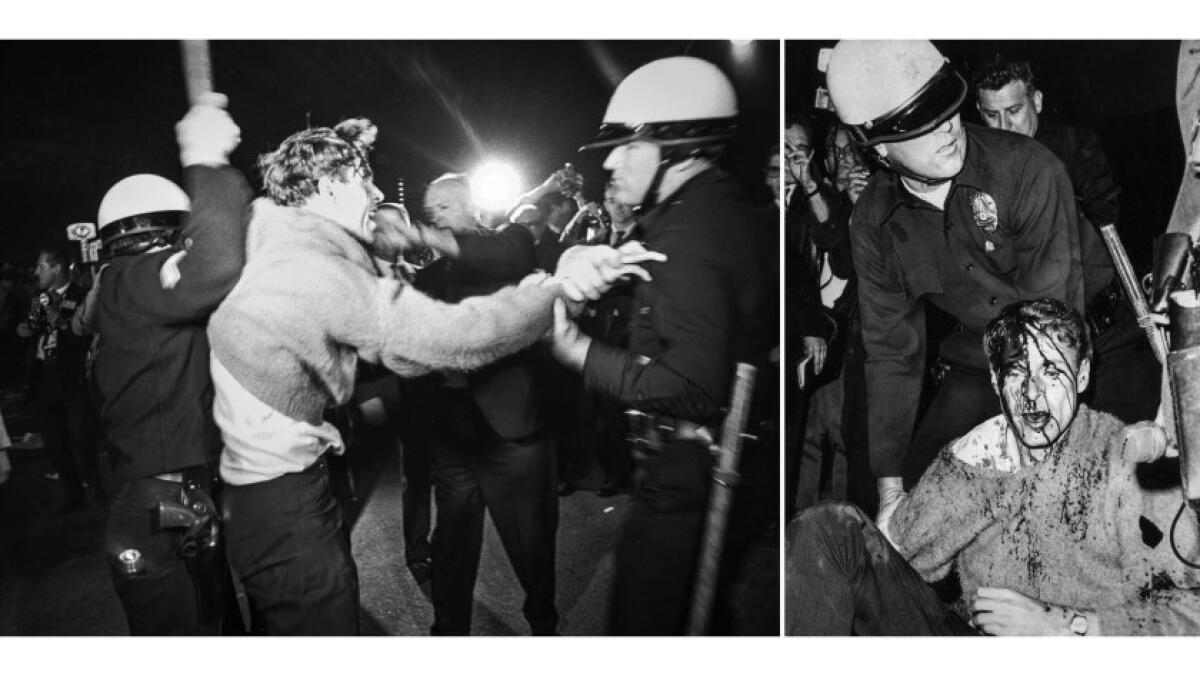 A young man resists police demands to disperse during antiwar protests at Century Plaza. He sits bleeding on the ground.