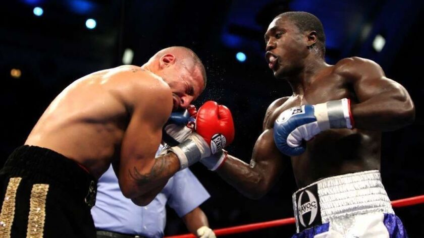 Andre Berto right, in a 2007 bout against David Estrada in Atlantic City. The former welterweight boxing champ is selling his Beverly Hills home.