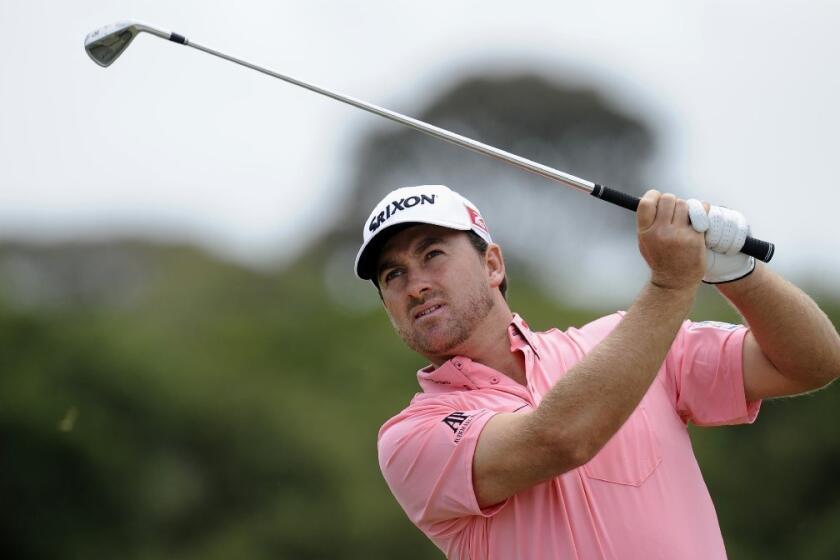 Graeme McDowell hits an approach shot at the World Cup of Golf in Australia.