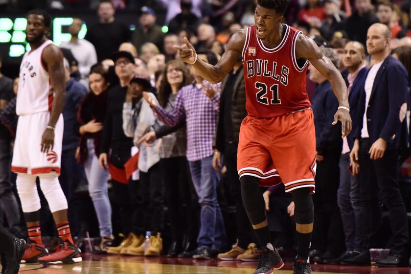 Bulls guard Jimmy Butler celebrates a three-point basket against the Toronto Raptors during his 40-point second half barrage.