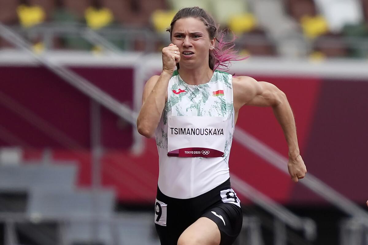 Krystsina Tsimanouskaya, of Belarus, runs in the women's 100-meter run.