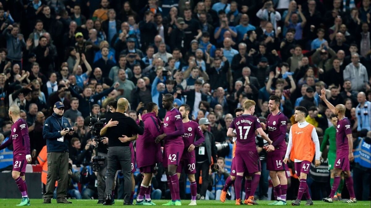 Manchester City players and fans celebrate after the English Premier League soccer match Tottenham Hotspur vs Manchester City at Wembley Stadium in London, Britain on April 14.