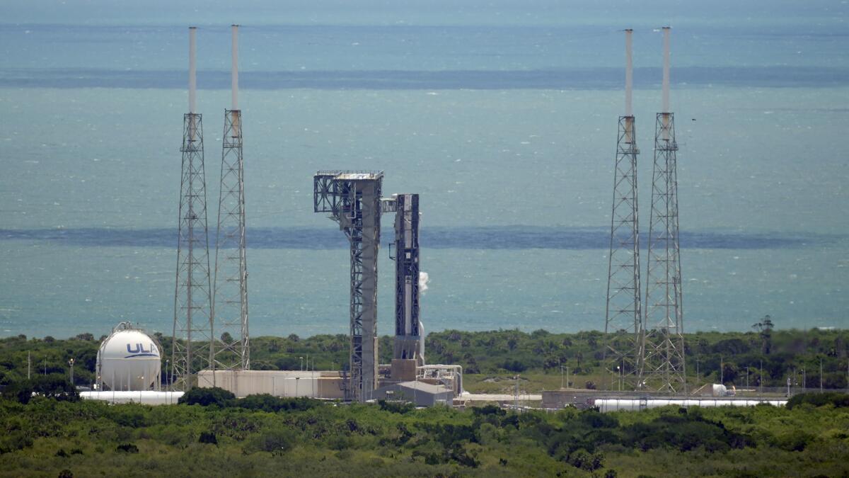 Boeing's Starliner capsule, atop an Atlas V rocket, sits on the launch pad.