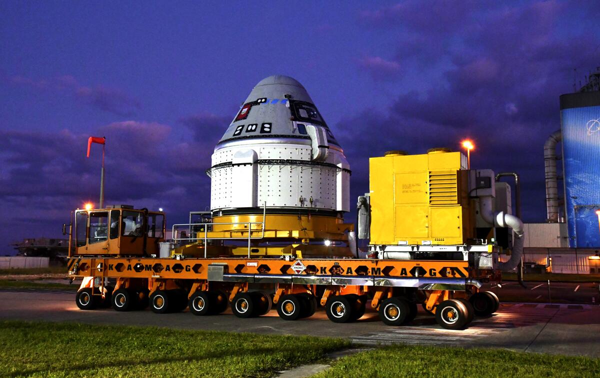 A trailer carries Boeing's Starliner craft.