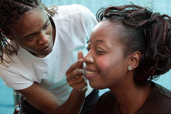 Lasandra Cooley, 28, left, helps Shelia Kenny, 40, with her makeup just before the dance routine at the second annual Miss Independence Day Pageant at Walden House, a residential treatment center for women halfway between prison and the daunting rest of their lives.