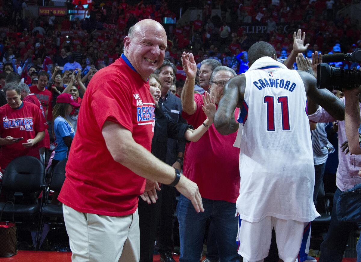 Clippers owner Steve Ballmer cheers on the players while Clippers guard Jamal Crawford greets fans after beating the San Antonio Spurs in Game 7 of a 2015 playoff series.