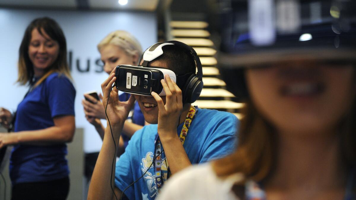 Nelson Zelaya, center, tries out the Oculus Rift virtual reality system at E3.