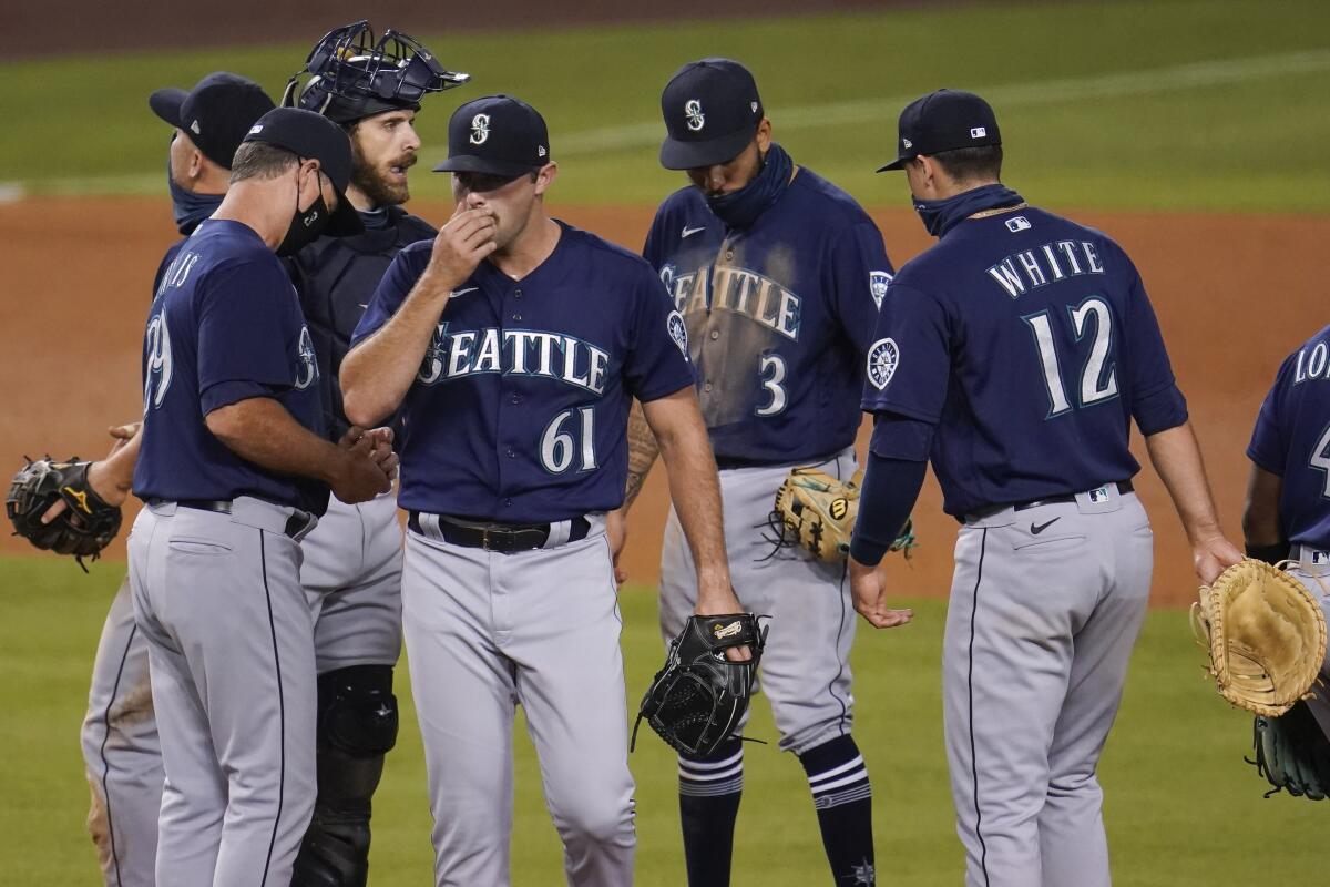 Mariners relief pitcher Matt Magill is pulled from the game by manager Scott Servais