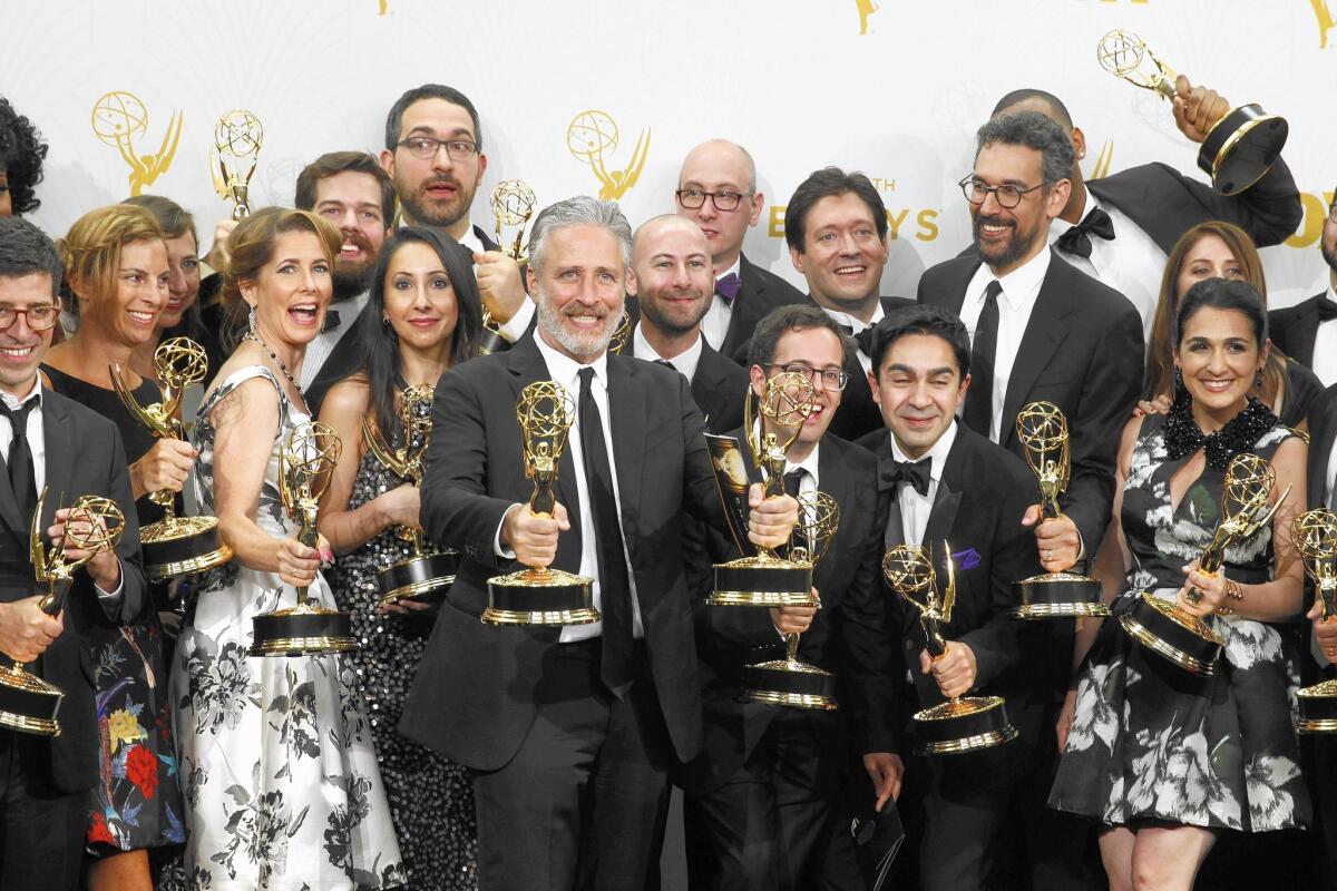 A bearded Jon Stewart, center, celebrates three Emmy victories with his former "Daily Show" staff.
