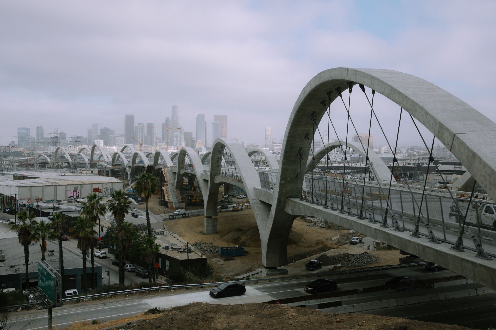 A view of the nearly completed 6th Street Viaduct from the east side of the L.A. River shows the bridge's repeating arches
