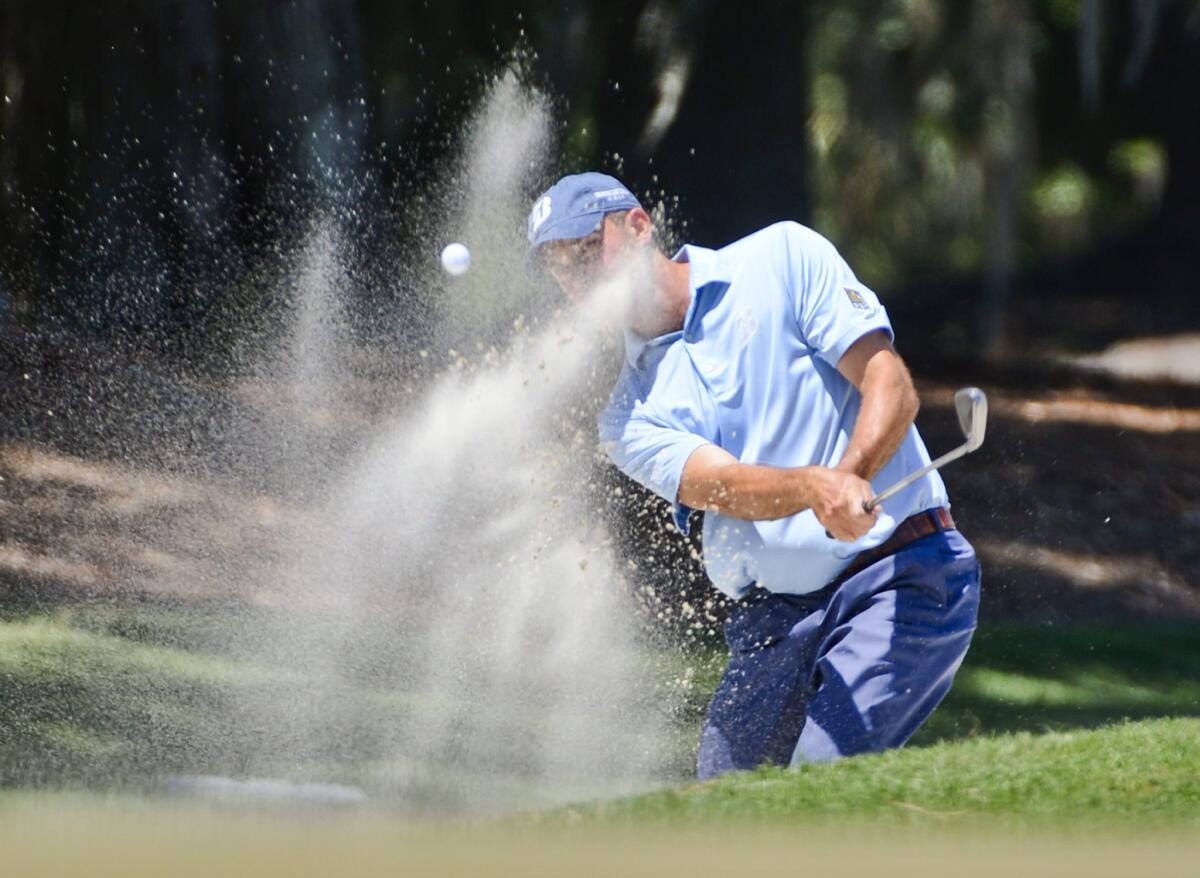 Matt Kuchar hits out of a sand trap in the 2012 Players Championship at TPC Sawgrass.