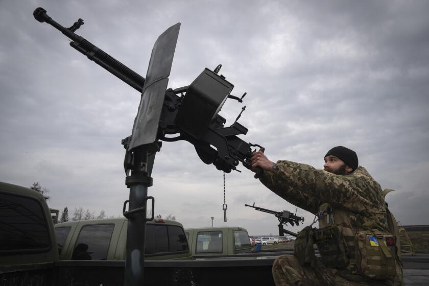 A Ukrainian soldier of a mobile air defence unit demonstrates his skills at the Antonov airport in Hostomel, on the outskirts of Kyiv, Ukraine, Saturday, April 1, 2023. (AP Photo/Efrem Lukatsky)