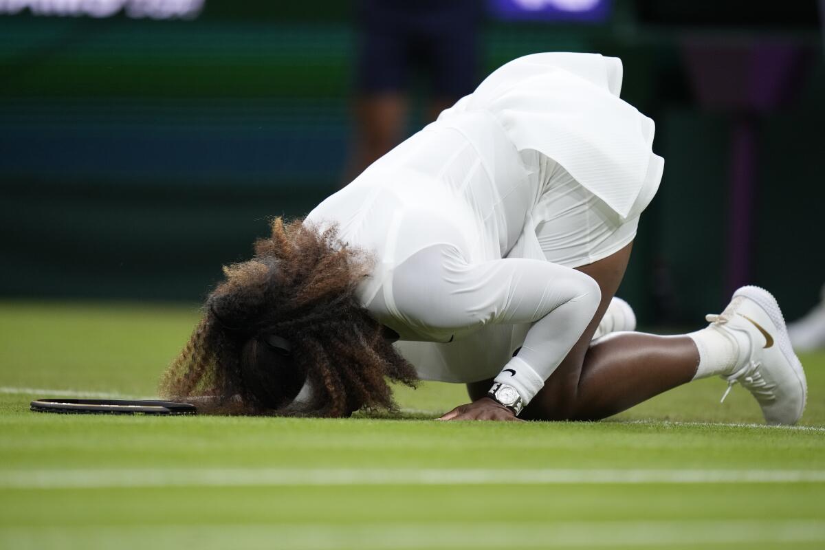 Serena Williams stumbles during a singles first-round match at Wimbledon 