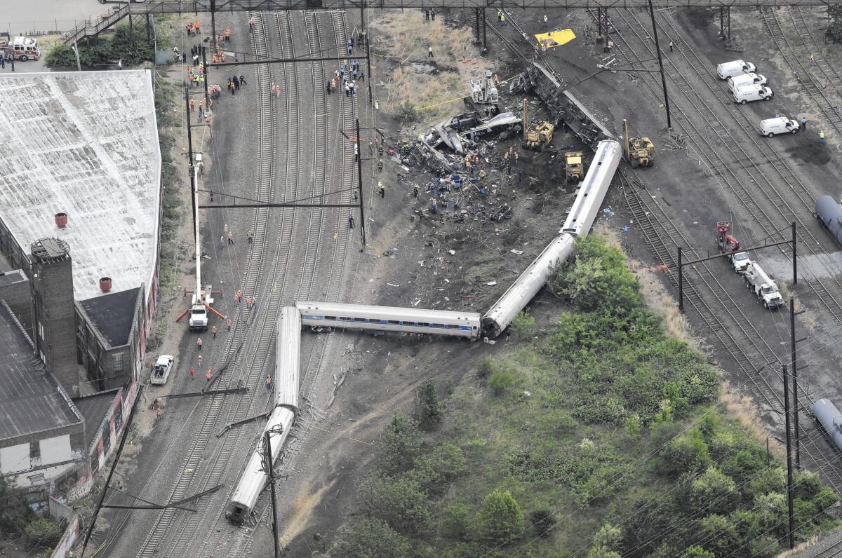 Emergency crews work at the site of the Philadelphia train derailment that occurred the night before.
