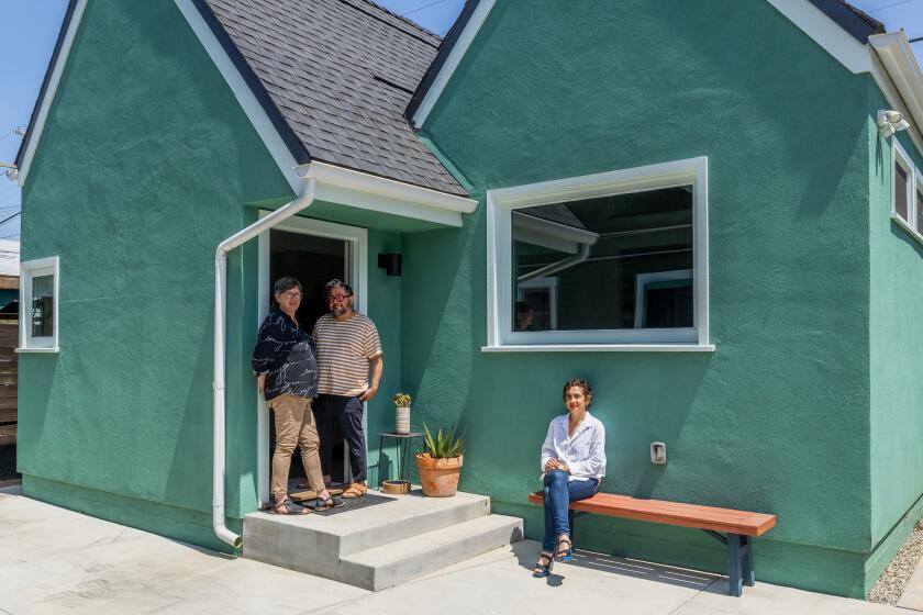 LOS ANGELES, CA - JUNE 19: Homeowners Julie Zemel and her husband Vladimir Gallegos (left) added a 650-square-foot ADU behind their 1890 home in Los Angeles for approximately $400,000. According to architect Rachel Allen (seated), the project is "informed by universal accessibility principles" and was originally commissioned during the COVID-19 pandemic to provide a safe place for the client's mother to age in place. A removal wheelchair ramp will be added to the front steps. Photographed on Wednesday, June 19, 2024. (Myung J. Chun / Los Angeles Times)