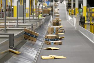 FILE - In this Dec. 17, 2019, file photo Amazon packages move along a conveyor prior to Amazon robots transporting packages from workers to chutes that are organized by zip code, at an Amazon warehouse facility in Goodyear, Ariz. Cashless shopping is convenient, but it can be a budget-buster. This year, make it more difficult to spend money online. This could help cut out some of your impulse purchases. (AP Photo/Ross D. Franklin, File)
