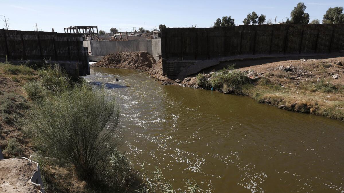 The New River flows through a 30-foot gap in the U.S.-Mexico border fence.