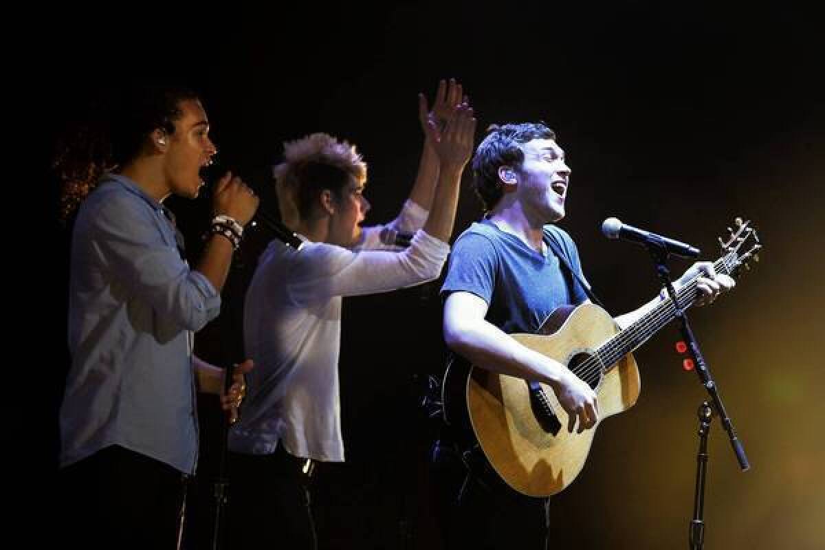 Deandre Brackensick, , left, Colton Dixon and Phillip Philips perform as part of the American Idol Live! tour.