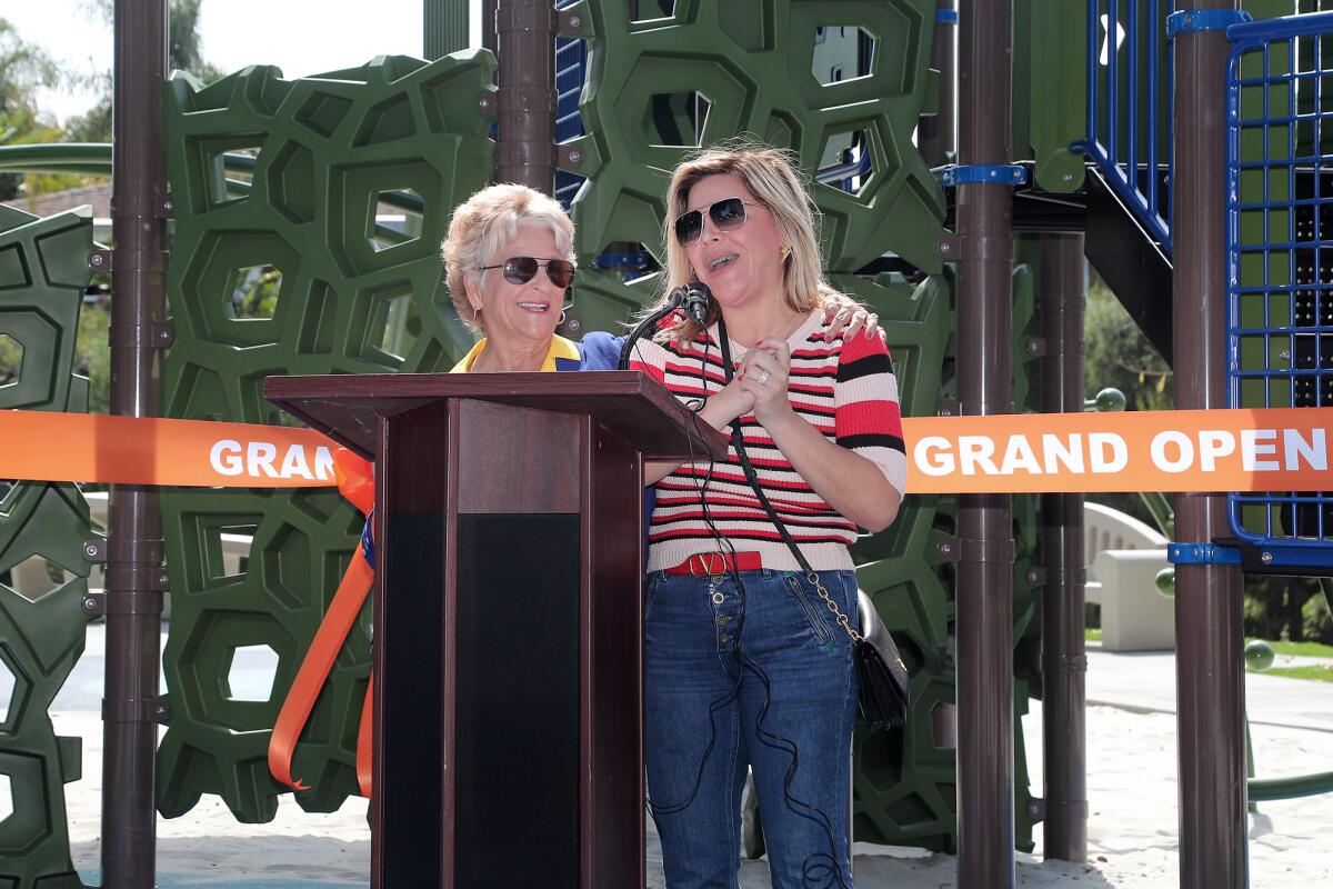 Michelle LeBron, right, is invited to speak by Councilwoman Joy Brenner, of District 6, during a ribbon-cutting event.