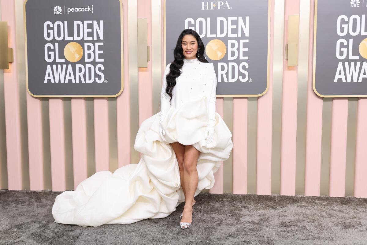 Chloe Flower dons a rouched white dress with a long train before a pink and grey step and repeat at the Golden Globes