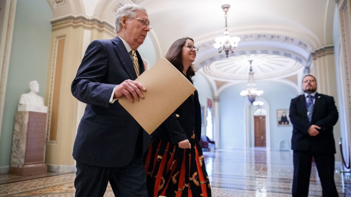 Senate Majority Leader Mitch McConnell heads to the Senate floor to speak about the Kavanaugh nomination on Tuesday.