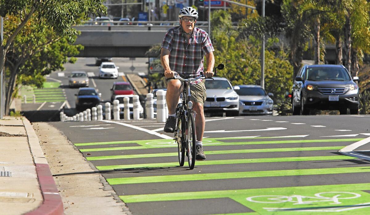 Brent Butterworth rides his bike on a protected bike lane on Reseda Boulevard. Officials say Mobility Plan 2035 will get people out of their cars.