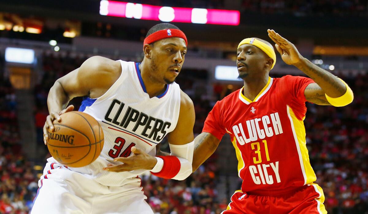 Clippers' Paul Pierce, left, works with the basketball in front of Houston's Jason Terry during the game on Wednesday.