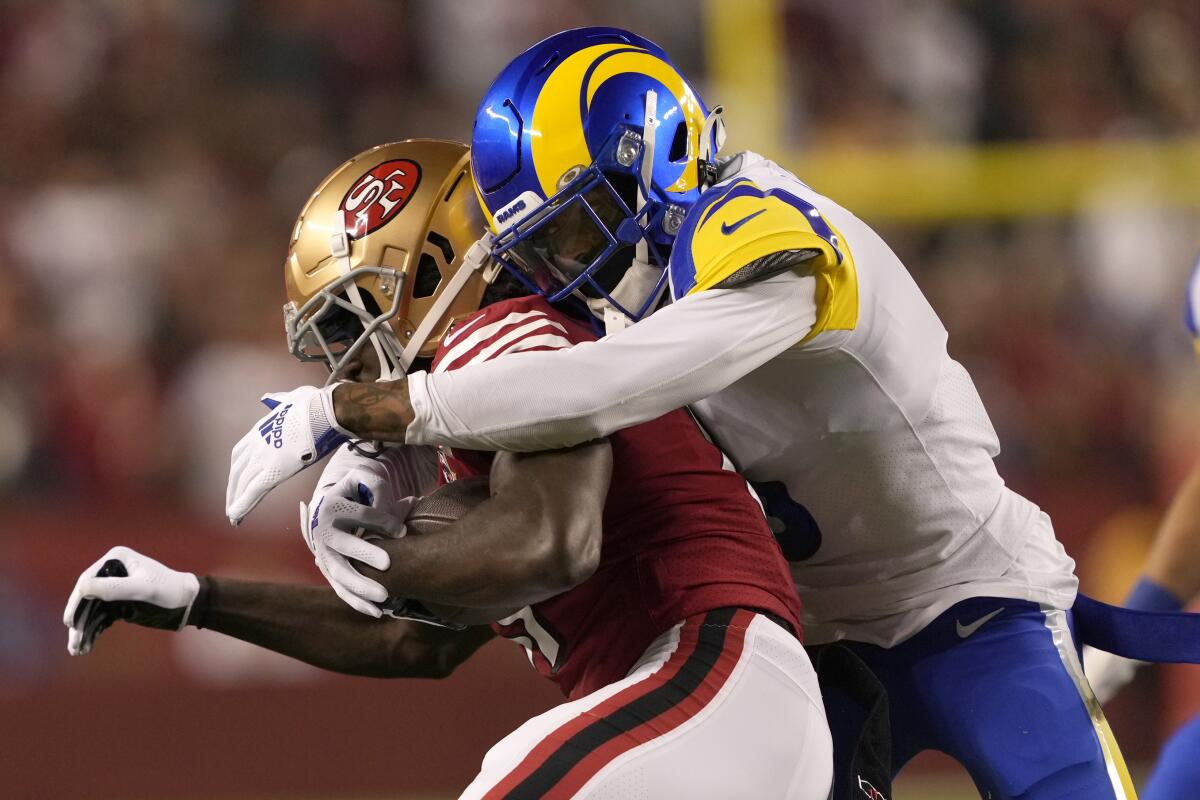 San Francisco 49ers wide receiver Brandon Aiyuk, left, is tackled by Rams cornerback Jalen Ramsey during the first half.